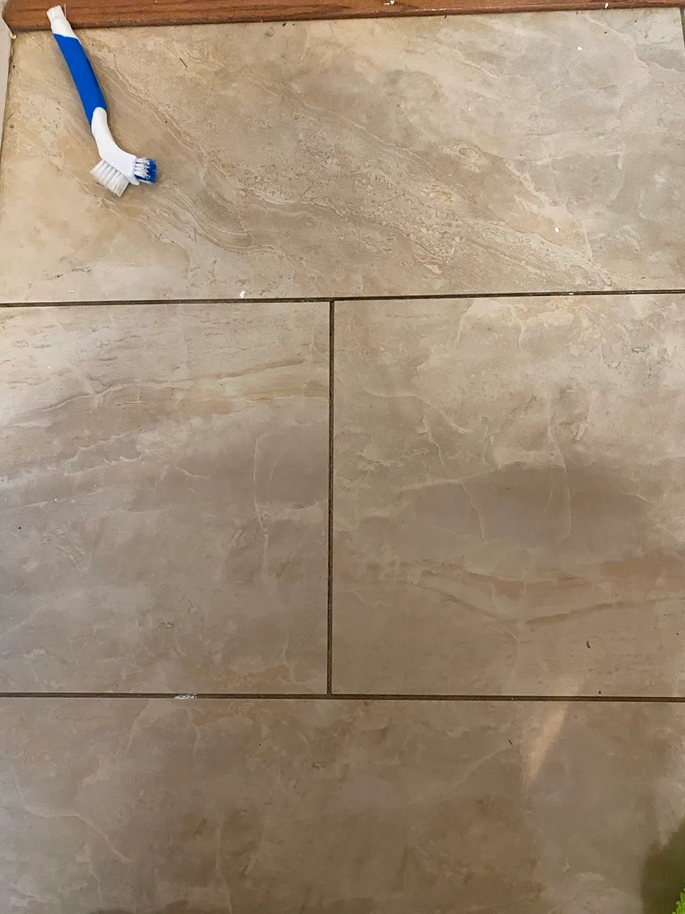 Tile floor grout being scrubbed with a detail brush in Lancaster County, PA