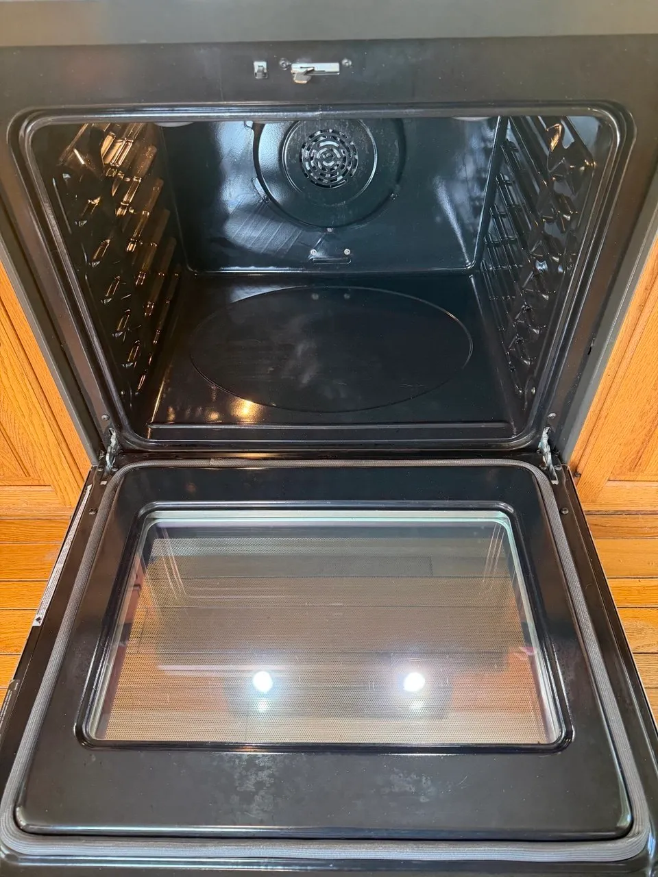 Oven interior after a deep clean, with clean racks, cavity and door glass