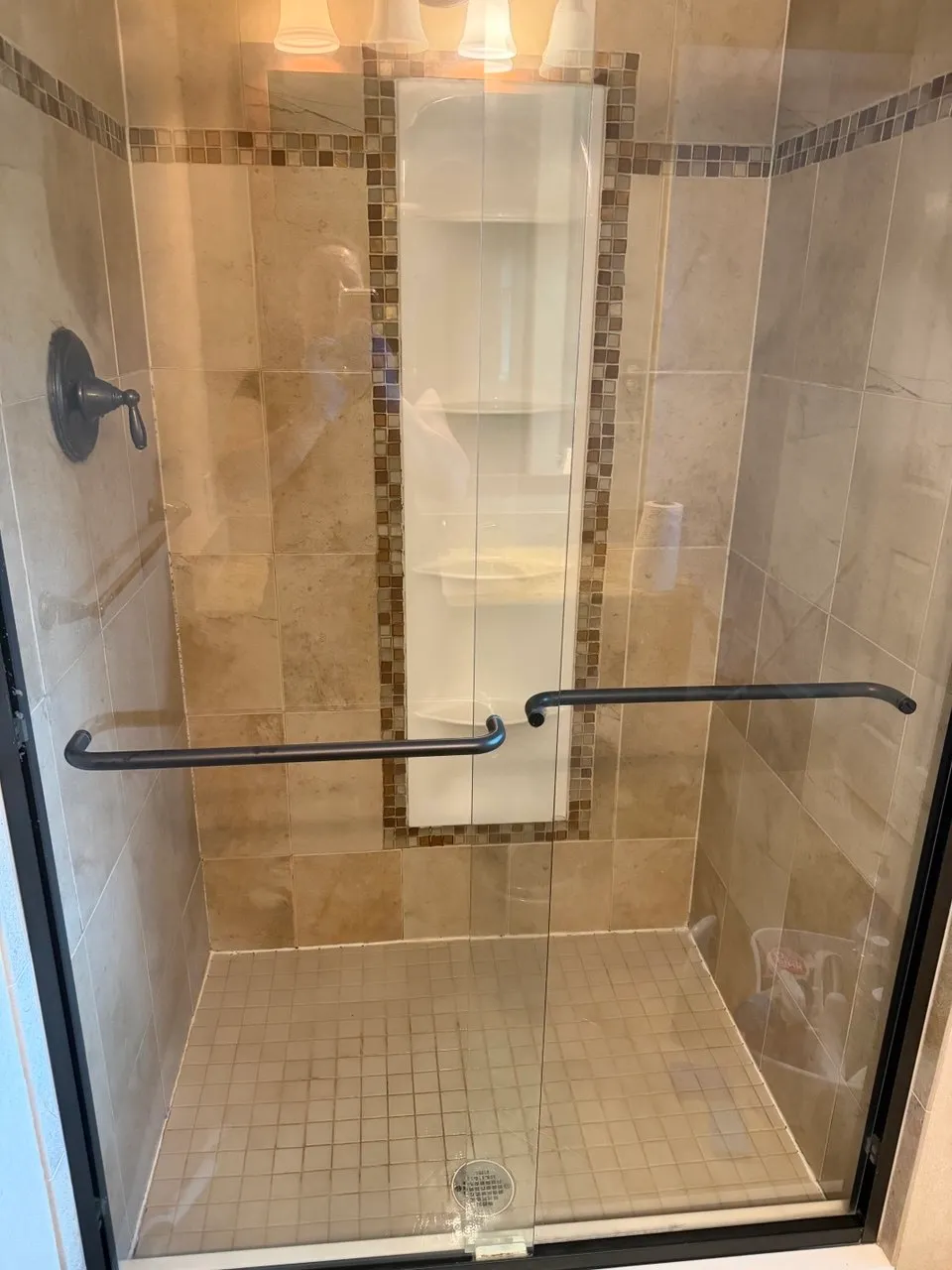 Tiled shower stall with glass door cleaned during a deep clean in Ephrata, PA